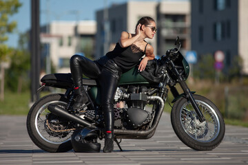 Plakat girl in black with a motorcycle