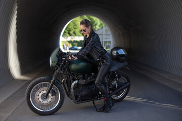 Fototapeta na wymiar girl in black with a motorcycle