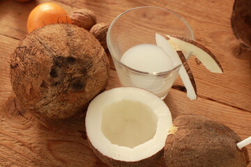 a sliced coconut with coconut milk in a glass