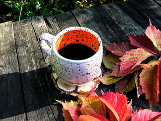 up of coffee with autumn leaves