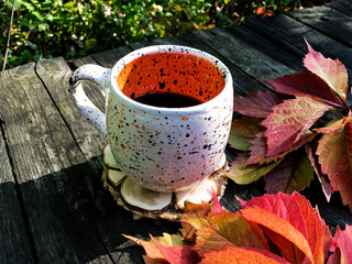 up of coffee with autumn leaves