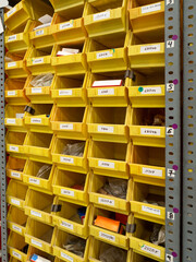 Storage equipment. Many yellow drawers on shelves for storing small tools and items at home, in the garage, in the workshop, in the warehouse.