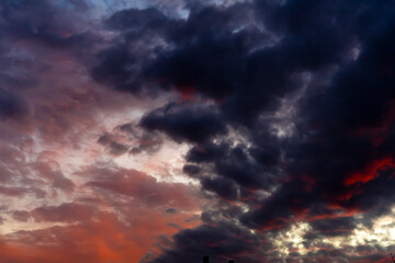 Clouds in the sky. Clouds at sunset. Sunset. The sky at sunset. Multi-colored clouds at sunset. Dark sky with clouds. Thick vapor texture. Natural abstraction. High in the sky. Dramatic background