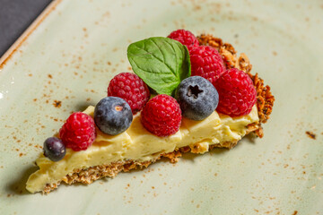 Cheesecake with raspberry and blueberry served on a plate