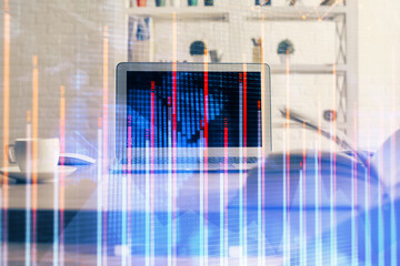 Financial chart drawing and table with computer on background. Double exposure. Concept of international markets.