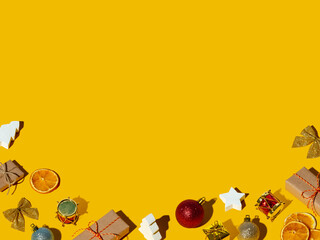 Orange Xmas background. Handmade gift decor set. Winter holidays pattern. Happy New Year. Rustic festive composition isolated on yellow empty space.