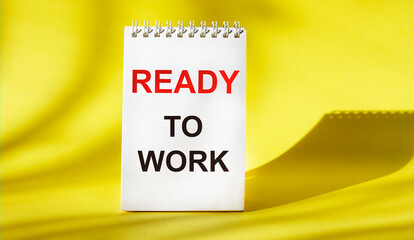 Ready to work , text written on white notepad and yellow background
