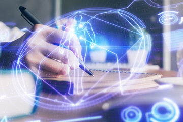 Education theme hologram over woman's hands writing background. Concept of study. Double exposure