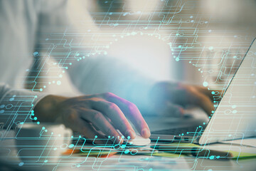 Businessman with computer background with technology theme hologram. Concept of hightech. Multi...