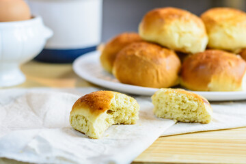 Fresh bun, kitchen utensils and eggs on wooden background, homemade bakery