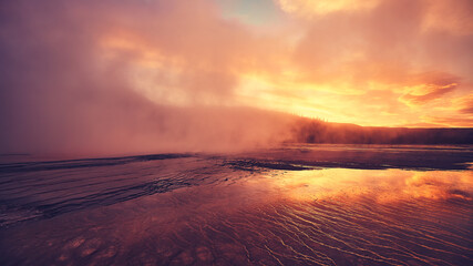 Fototapeta na wymiar Purple sunset at steaming Grand Prismatic Spring in Yellowstone National Park, USA.