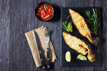 Traditional smoked halibut fish steaks with lime