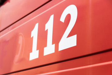 112 the emergency number on a red background - obrazy, fototapety, plakaty