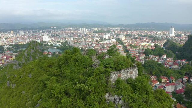 Aerial landscape: Ancient wall of The Mac dynasty as known as Northern Mac or House of Mac, old ruins located on a mountain with panoramic city Lang Son backwards, Vietnam.