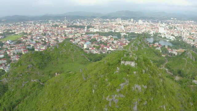 Aerial landscape: Ancient wall of The Mac dynasty as known as Northern Mac or House of Mac, old ruins located on a mountain with panoramic city Lang Son backwards, Vietnam.