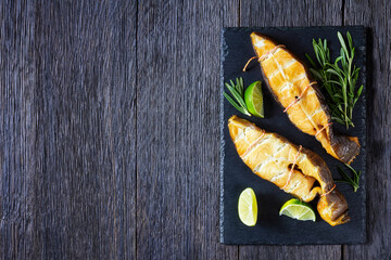 Traditional smoked halibut fish steaks with lime