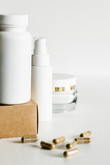 Herb capsules and white bottles, healthcare and beauty concept. 
