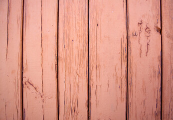 Wooden plank wall. The paint is cracked and peeling.