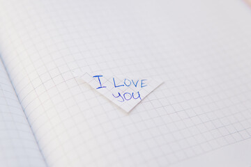  I love you written in english on a notebook paper.