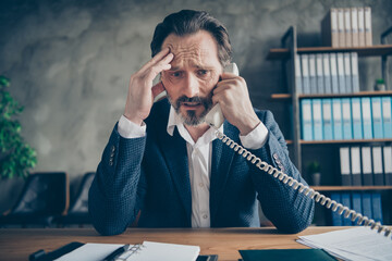 Close-up portrait of his he depressed miserable jobless middle-aged guy employee talking on phone...