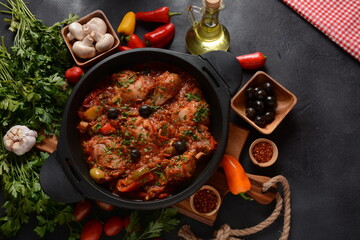 Chicken cacciatore with bell peppers, tomatoes, black olives. Italian food