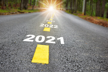 New year journey 2021 to 2024 on asphalt road surface with marking lines and sunlight. Business...