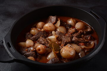 Greek beef stifado. Stew with beef, onion bulbs, cinnamon and spices 