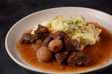Greek beef stifado. Stew with beef, onion bulbs, cinnamon and spices 