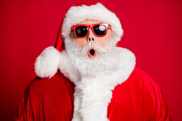 Close-up portrait of his he nice handsome amazed bearded Santa father St Nicholas pout lips cool celebratory event season sale isolated bright vivid shine vibrant red color background