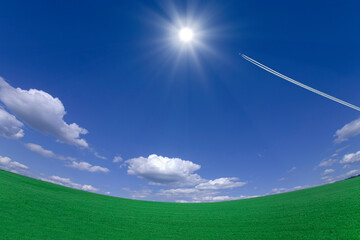 Obraz na płótnie Canvas 草原と太陽と飛行機雲