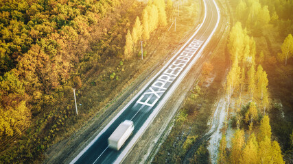 Fototapeta premium Truck traveling on road at sunrise - speed and delivery concept. Motion blur