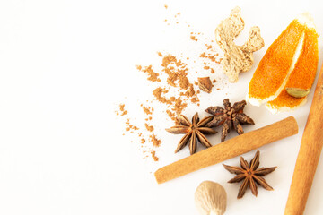 cinnamon stick, cinnamon powder, star anise, orange peel, dried ginger on white background