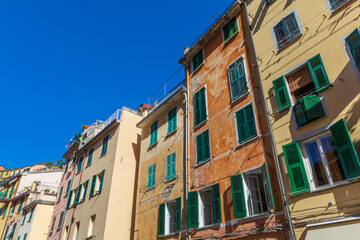 Fototapeta premium Ancient colorful houses. Perspective of the external facades of the buildings. Location: Riomaggiore in Liguria in Italy.