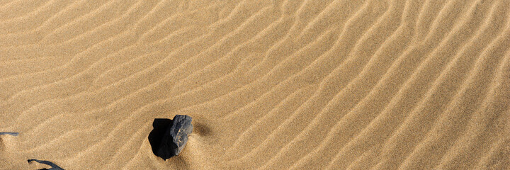 Fototapeta na wymiar Closeup sand on the beach formed by wind. Panoramic image