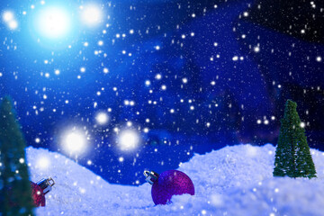 Fototapeta na wymiar Christmas background with Christmas balls on snow over fir-tree, night sky and moon. Shallow depth of field. Christmas background. Fairy tale. Macro. Artificial magic dreamy world.