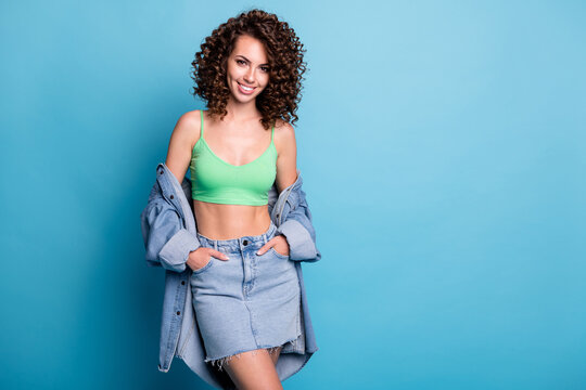 Photo of sweet nice pretty girl lady model look direct camera casual summer outfit brand beauty studio advert concept wear jeans jacket skirt green top isolated pastel blue color background