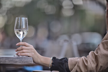 white wine glass in an outdoor cafe, spring view in a restaurant