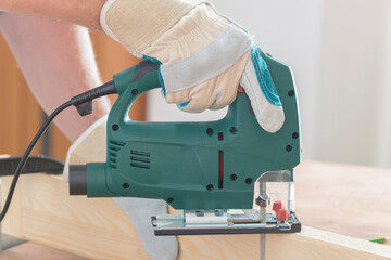 Cutting a piece of wood using a jigsaw