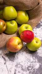 A bunch of red and green apples in a bag on a black and white background,close-up,background,Wallpaper,postcard,advertising