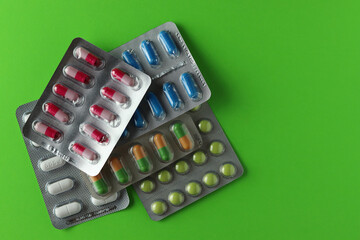 Pills isolated on green background