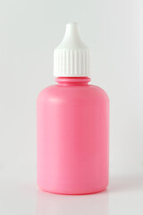 Cosmetic pink bottle isolated on white background