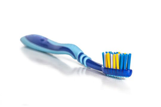 Blurred toothbrush, with focus on multi-colored bristles