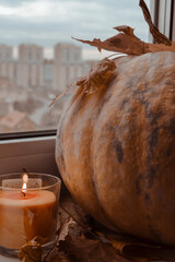 halloween pumpkin with candles on the windowsill