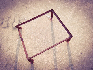 Red old rusty Iron frame with red tyres looking beautiful in morning sunlight with shadows