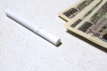 Cigarette and Wad of bills (Japanese yen) 増税！値上げ！タバコと現金