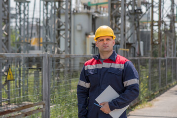 The energy engineer inspects the equipment of the substation. Power engineering. Industry.