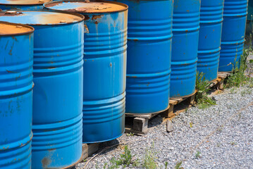 Big oil drums, blue. Chemical barrels in an open warehouse. Rusty barrels. Barrel for oil