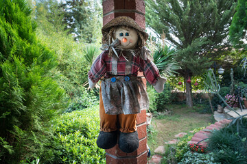 Beatiful toy doll puppets in green and treeed garden.