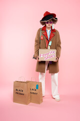 woman in sunglasses and hats with sale tags holding carton box with favorite shoes lettering near...