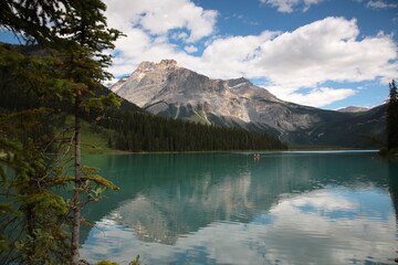 View of Bow lake with people Canoeing on lake during summer in Banff National Park, Canadian Rockies, Alberta, Canada.
